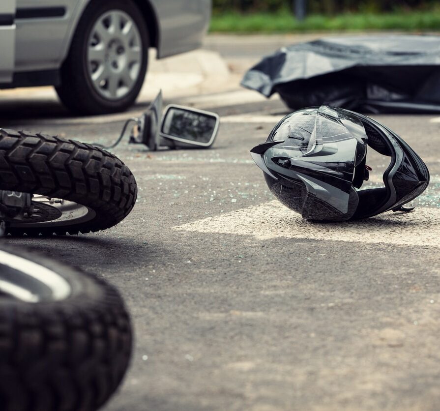Motorcycle and helmet on the street after dangerous traffic incident