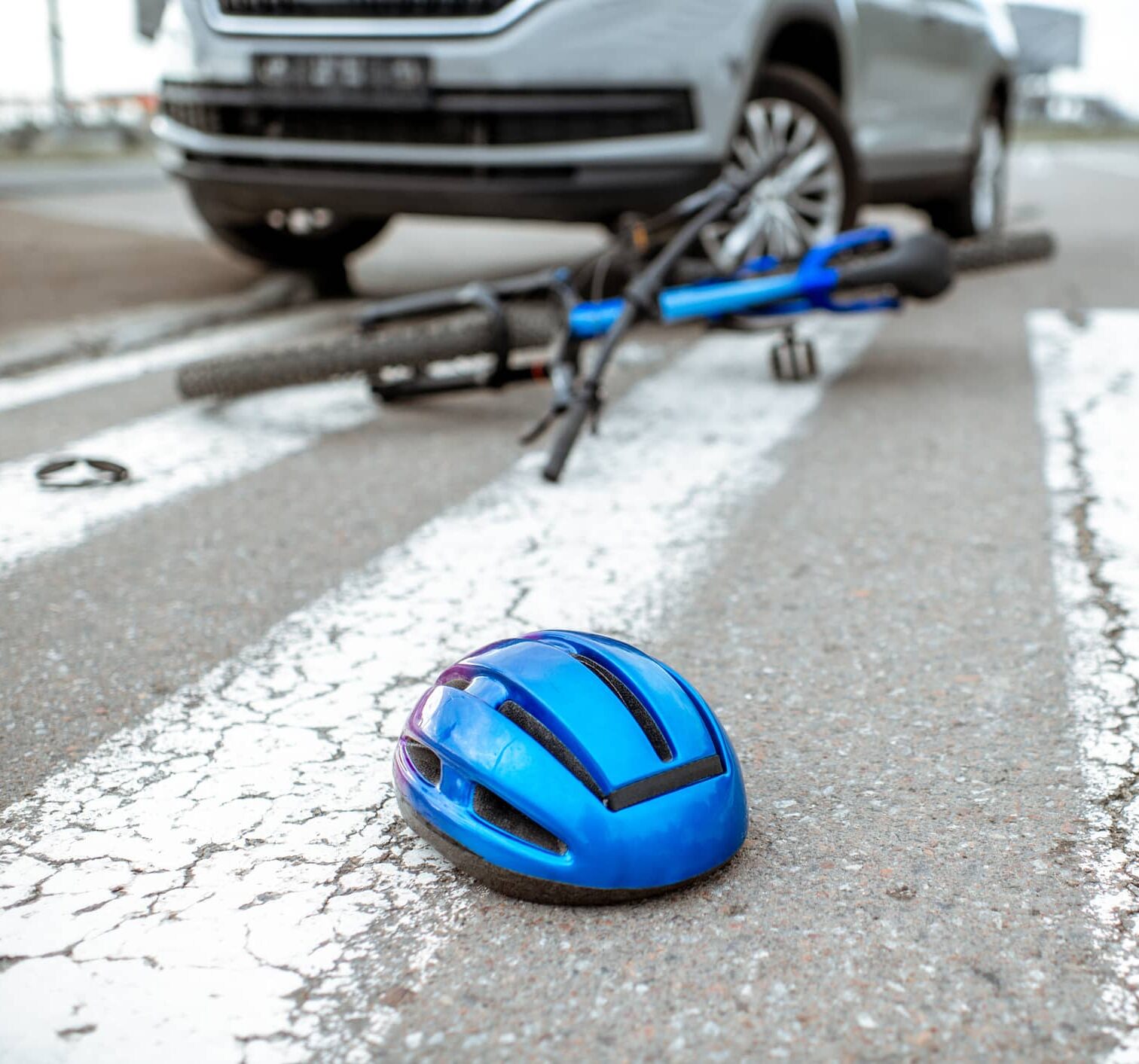 Road accident with car and broken bicycle