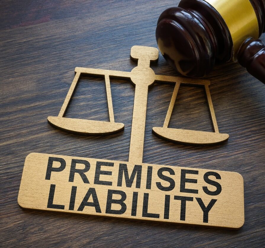 Plate with inscription Premises liability and gavel.