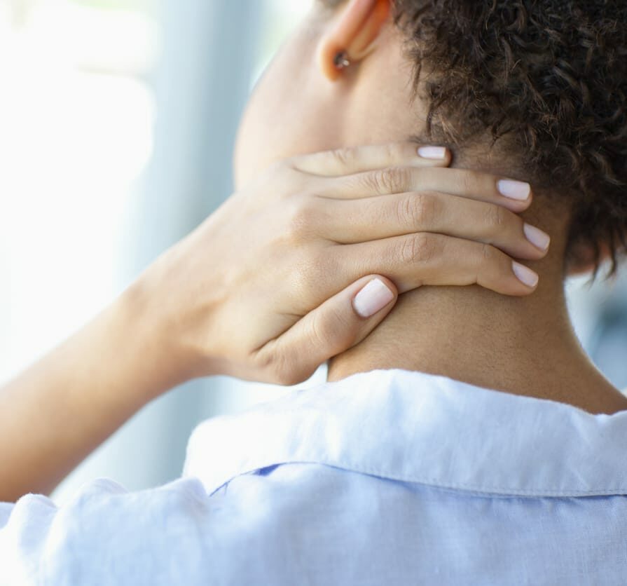 Woman rubbing sore neck