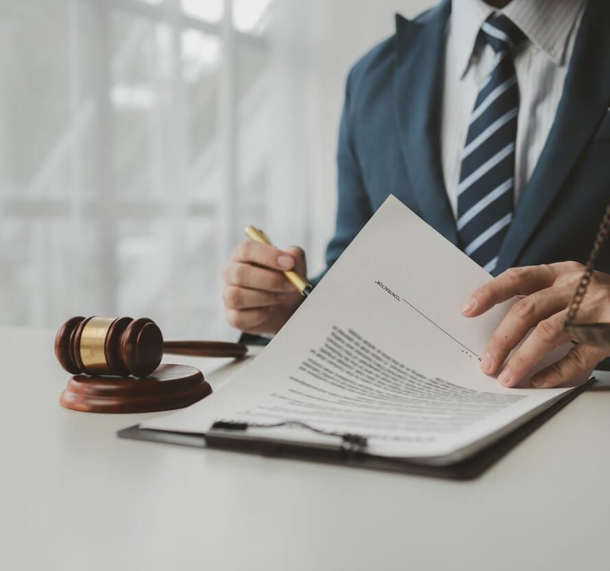 Lawyer is signing papers in the office