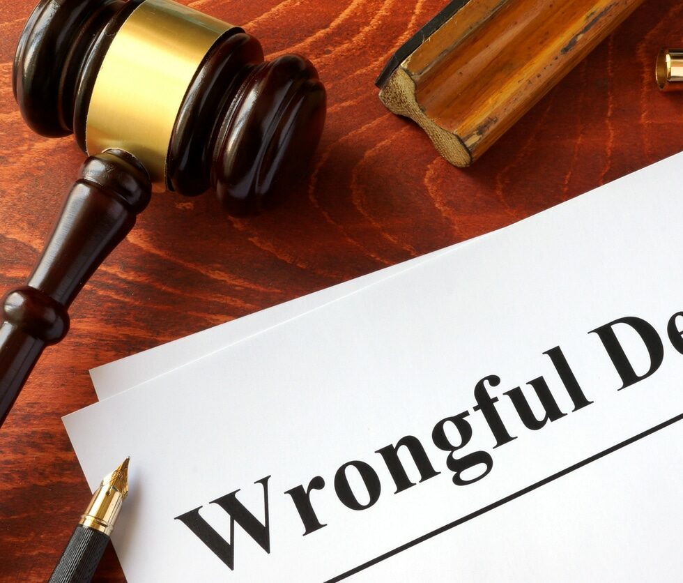 Document with title Wrongful Death on a wooden surface.